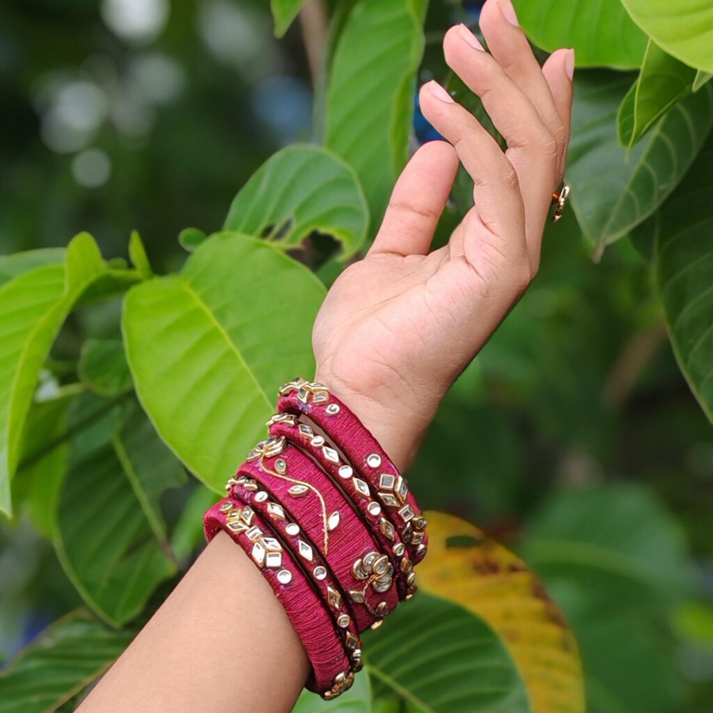 Maroon silk thread bangles worn on the wrist